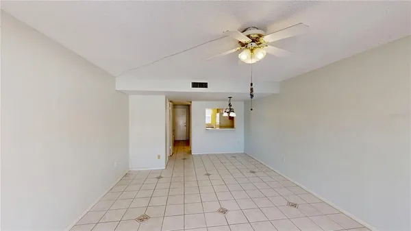 a living room with furniture a flat screen tv and a window