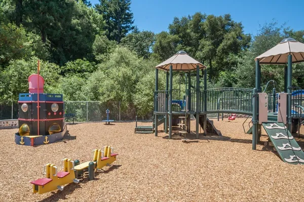 a view of backyard with a slide and slide