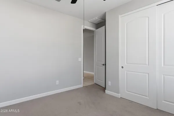 a view of an empty room and closet area