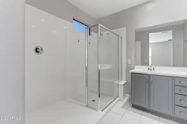 a bathroom with a shower sink and mirror