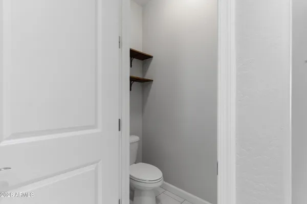 a bathroom with a granite countertop toilet and a sink