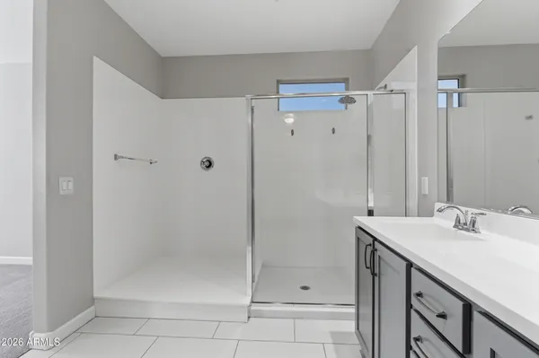 a bathroom with a shower sink and mirror