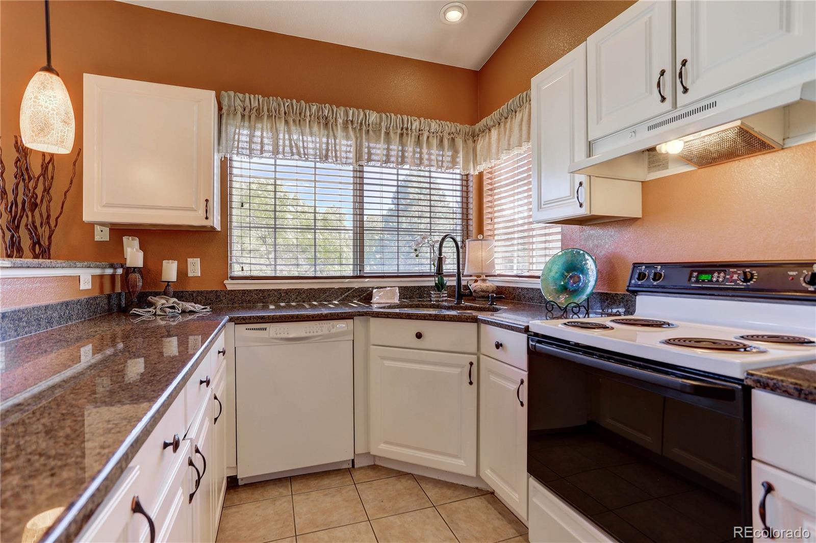 6830 Xavier Circle, Unit 3 Arvada, CO 80030 - Photo 11 of 28 a kitchen with a sink stove and cabinets