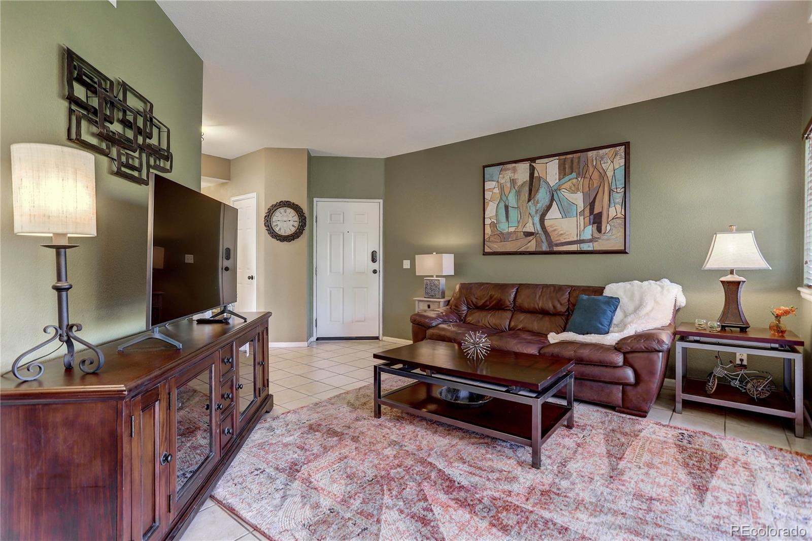 6830 Xavier Circle, Unit 3 Arvada, CO 80030 - Photo 12 of 28 a living room with furniture and a flat screen tv