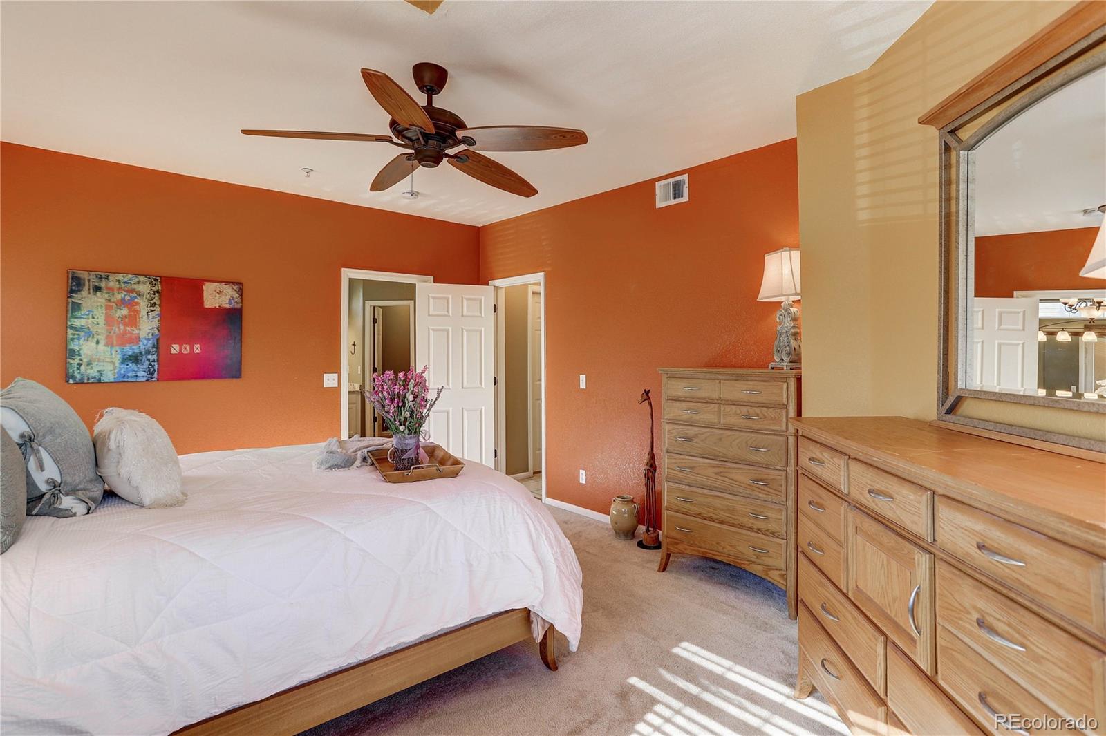 6830 Xavier Circle, Unit 3 Arvada, CO 80030 - Photo 16 of 28 a bedroom with a bed and ceiling fan