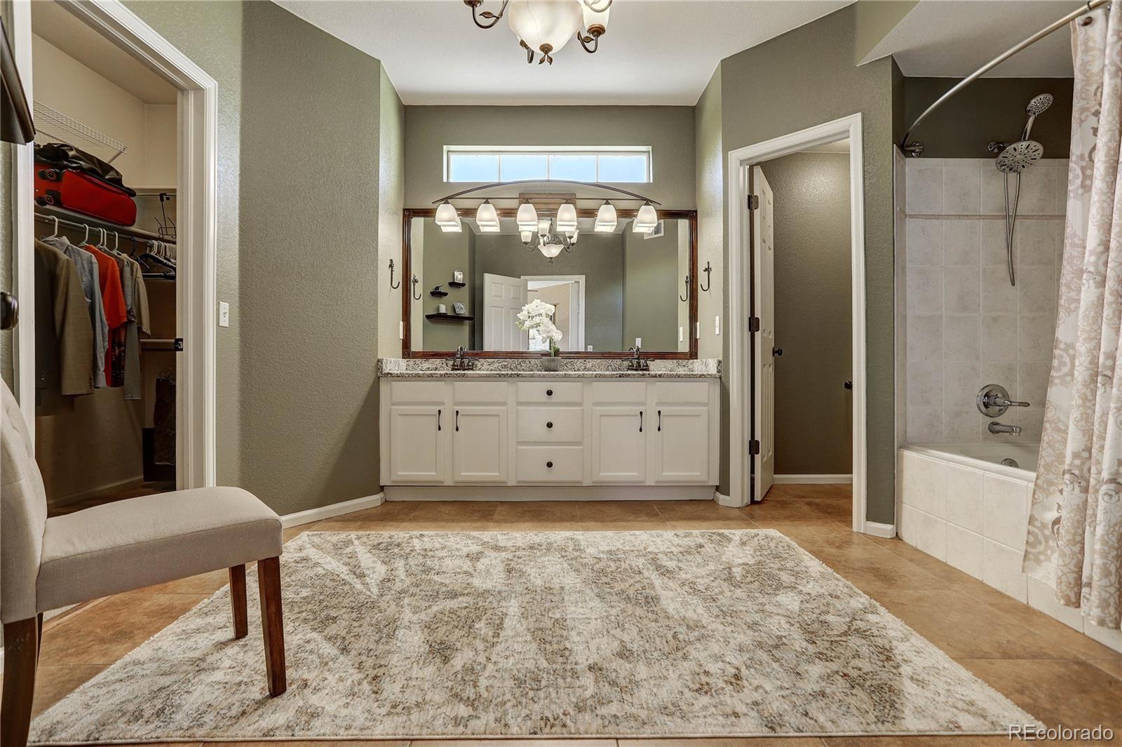 6830 Xavier Circle, Unit 3 Arvada, CO 80030 - Photo 17 of 28 a view of a bathroom with a tub and shower