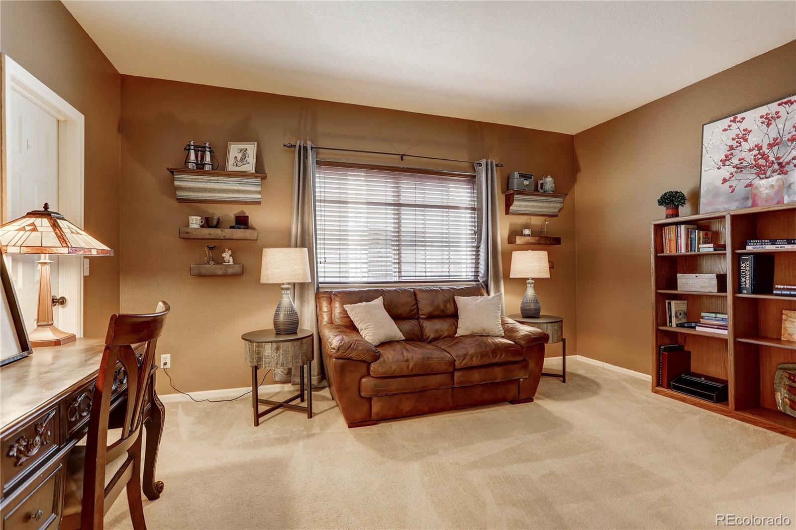 6830 Xavier Circle, Unit 3 Arvada, CO 80030 - Photo 20 of 28 a living room with furniture and a window