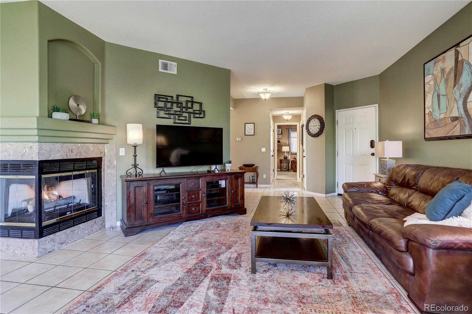 6830 Xavier Circle, Unit 3 Arvada, CO 80030 - Photo 6 of 28 a living room with furniture flat screen tv and a fireplace