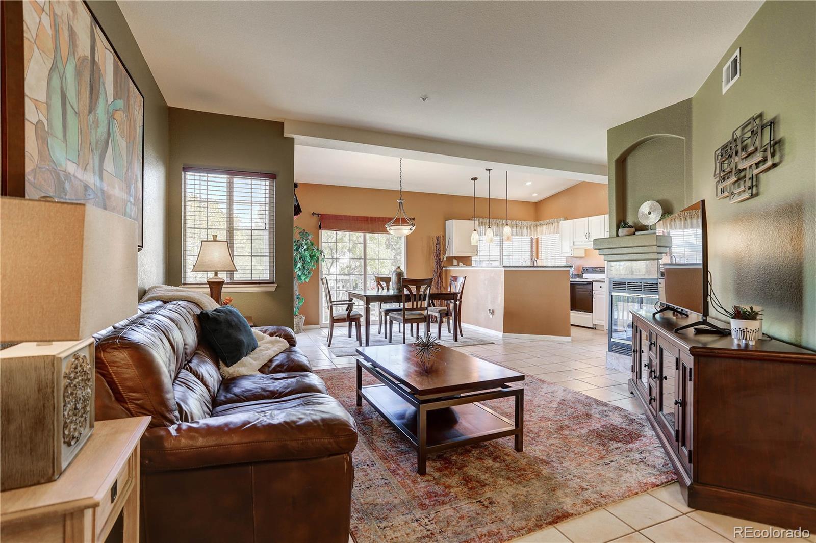 6830 Xavier Circle, Unit 3 Arvada, CO 80030 - Photo 7 of 28 a living room with furniture a rug and a flat screen tv