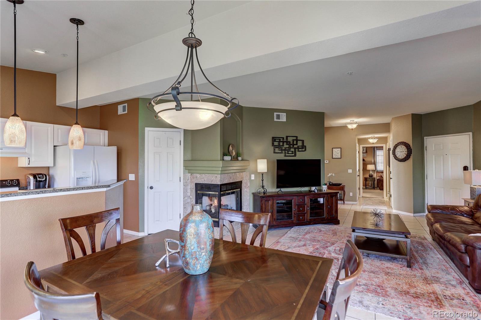 6830 Xavier Circle, Unit 3 Arvada, CO 80030 - Photo 9 of 28 a living room with fireplace furniture and a flat screen tv