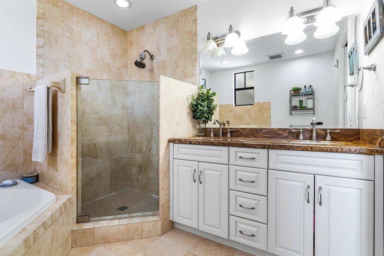 507 Southwest 17th Street Fort Lauderdale, FL 33315 - Photo 15 of 25 a bathroom with a granite countertop sink a mirror a shower and a bathtub