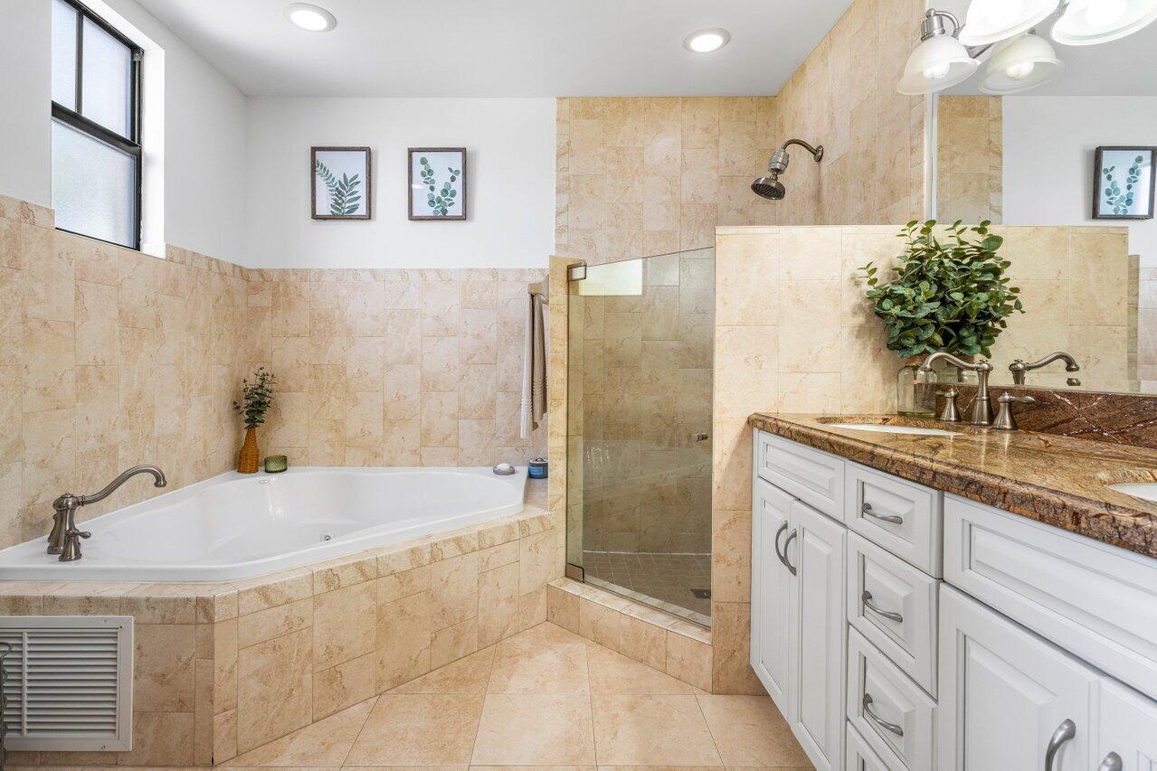 507 Southwest 17th Street Fort Lauderdale, FL 33315 - Photo 16 of 25 a bathroom with a granite countertop sink a mirror a bathtub and shower
