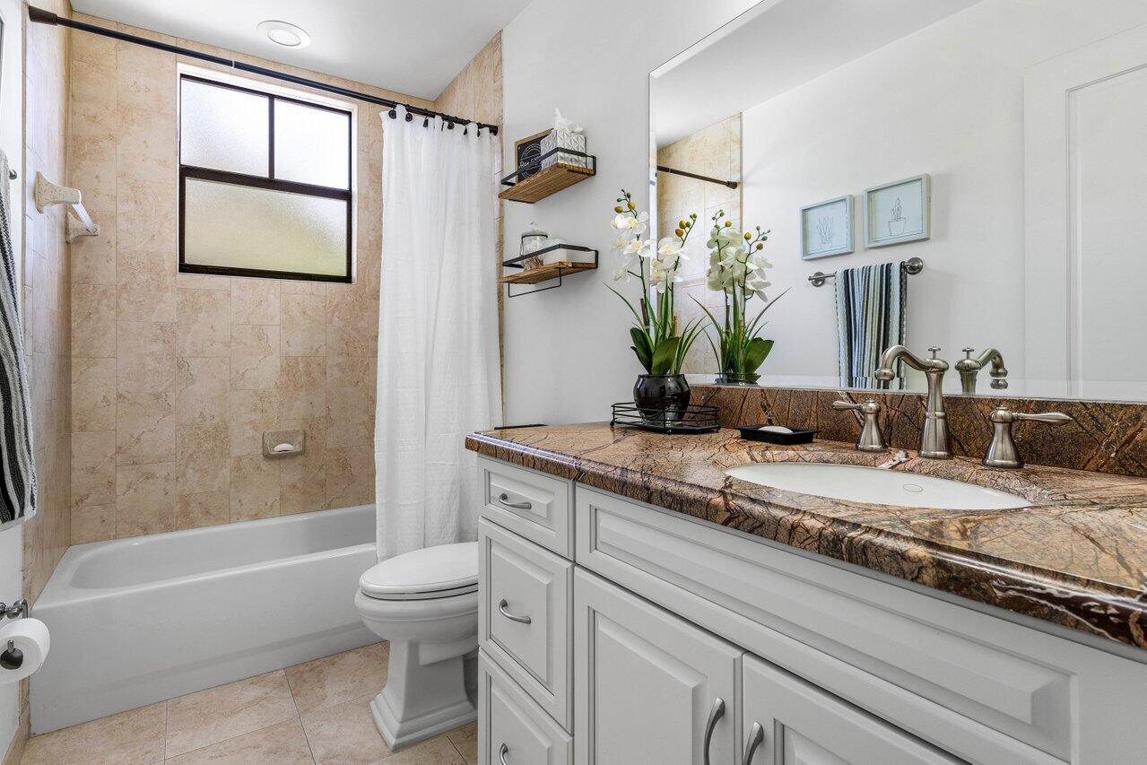 507 Southwest 17th Street Fort Lauderdale, FL 33315 - Photo 22 of 25 a bathroom with a granite countertop sink a toilet and shower