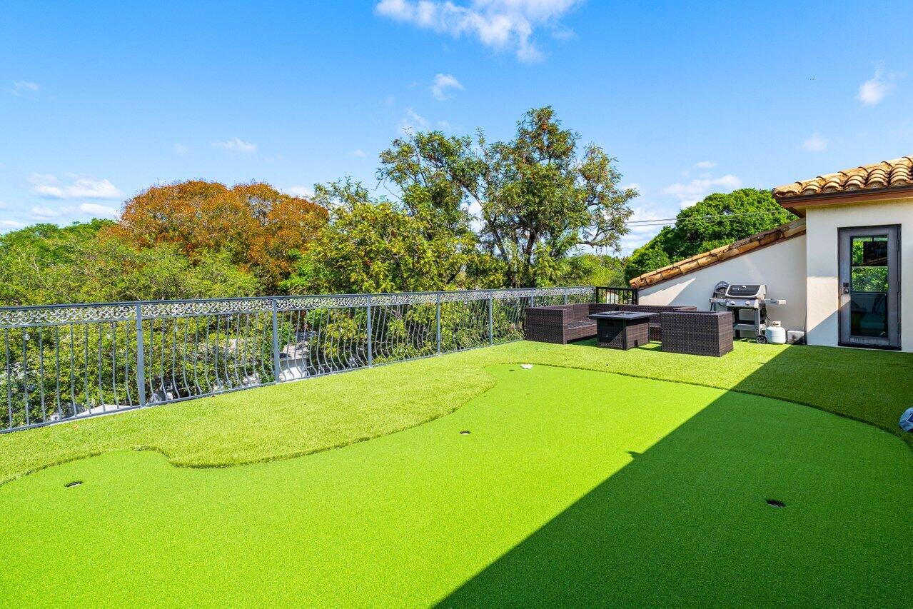 507 Southwest 17th Street Fort Lauderdale, FL 33315 - Photo 23 of 25 a view of a house with a backyard and a patio