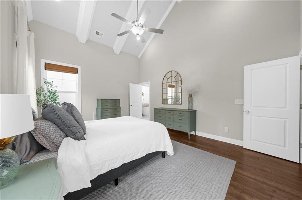 320 Senna Street Marietta, GA 30064 - Photo 28 of 53 a bedroom with a large bed and wooden floor