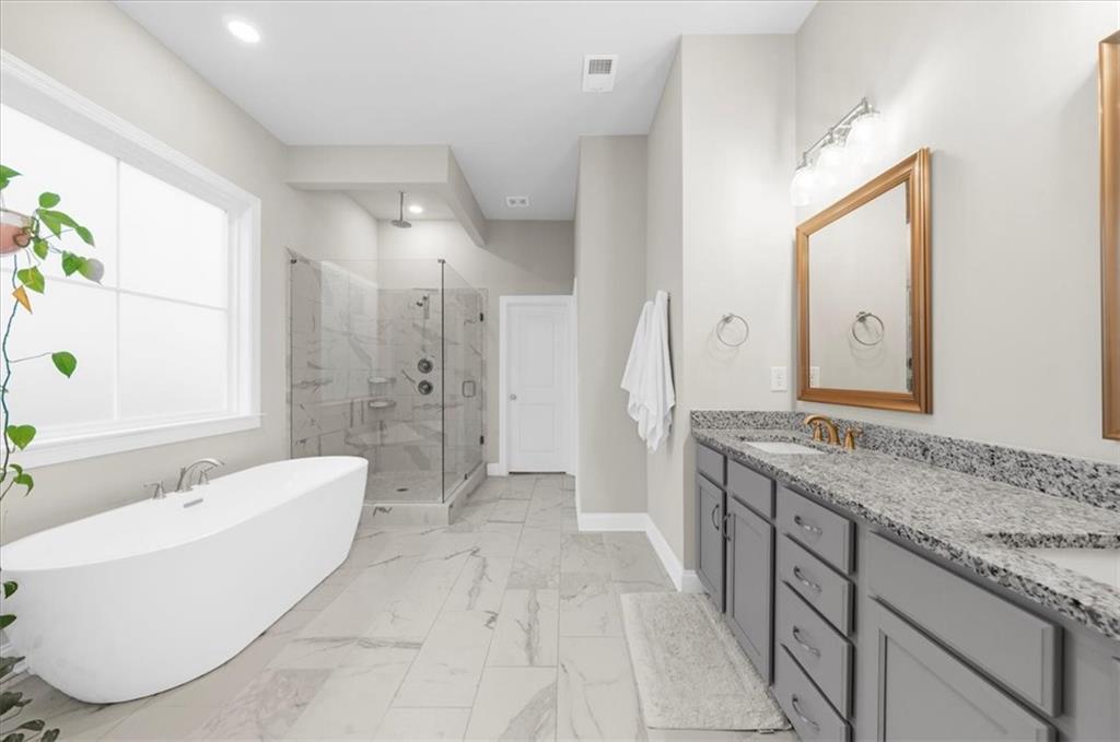 320 Senna Street Marietta, GA 30064 - Photo 29 of 53 a spacious bathroom with a granite countertop tub sink and mirror