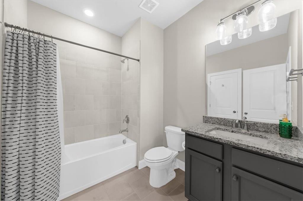 320 Senna Street Marietta, GA 30064 - Photo 36 of 53 a bathroom with a granite countertop sink toilet a large mirror a bathtub and shower