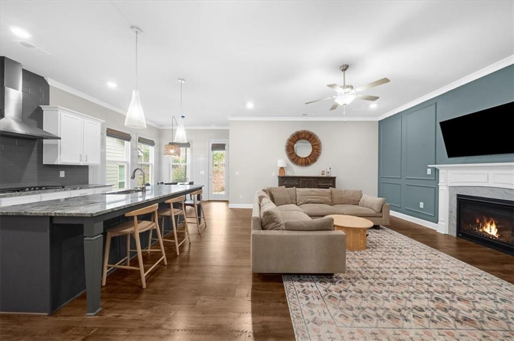 320 Senna Street Marietta, GA 30064 - Photo 9 of 53 a living room with furniture a fireplace and a flat screen tv