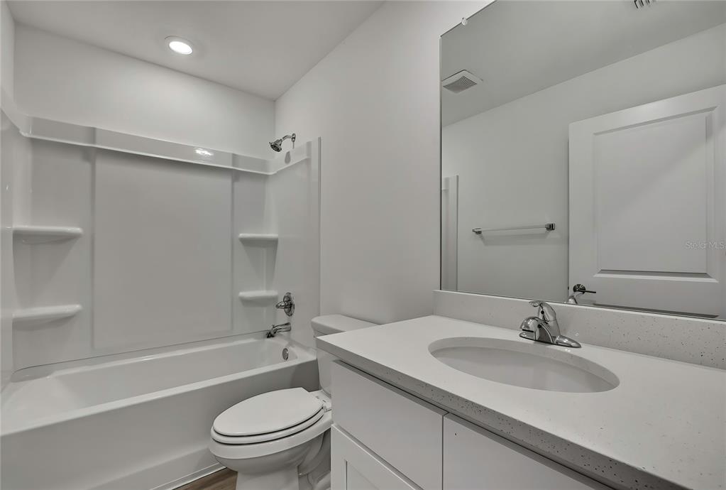 3646 Portillo Road Spring Hill, FL 34608 - Photo 12 of 16 a bathroom with a sink toilet vanity and shower