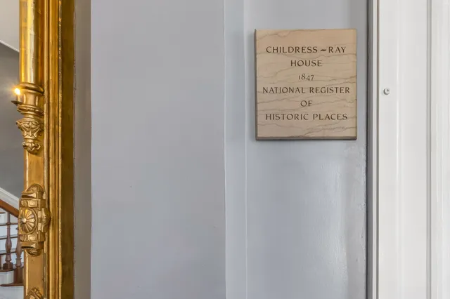 a sign on a wall next to a window