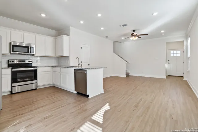 a view of kitchen with wooden floor and electronic appliances