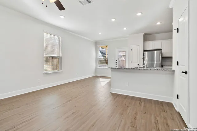 a kitchen with stainless steel appliances kitchen island hardwood floor sink and stove