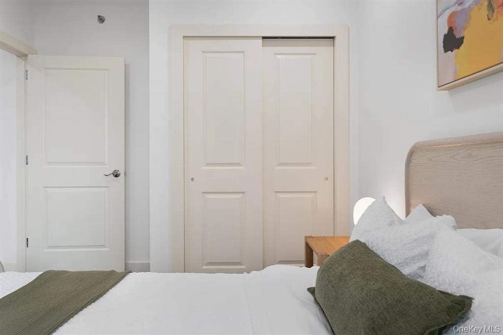 124-28 Queens Boulevard, Unit 10C Queens, NY 11415 - Photo 10 of 14 Bedroom featuring a closet