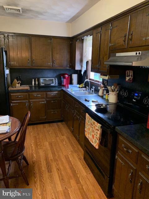 155 Farm Valley Road Wellsville, PA 17365 - Photo 14 of 31 a kitchen with stainless steel appliances granite countertop a sink stove and cabinets