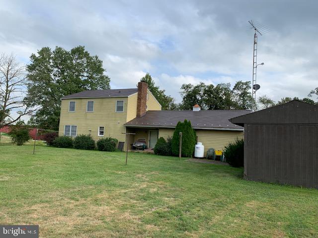 155 Farm Valley Road Wellsville, PA 17365 - Photo 5 of 31 a front view of a house with a yard and garage