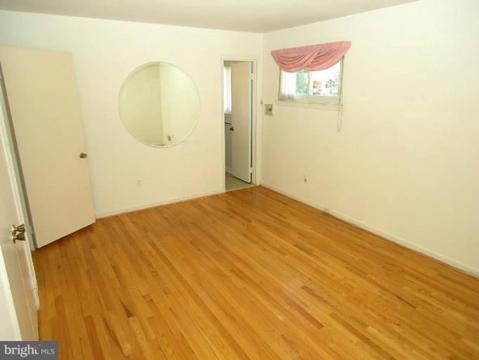 1204 Smith Village Road Silver Spring, MD 20904 - Photo 14 of 17 a view of a room with wooden floor and cabinet
