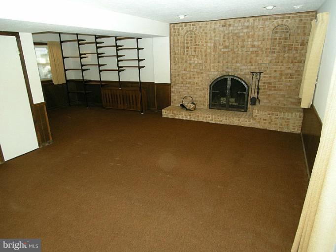 1204 Smith Village Road Silver Spring, MD 20904 - Photo 16 of 17 a view of livingroom with furniture and a fireplace