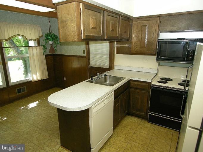 1204 Smith Village Road Silver Spring, MD 20904 - Photo 10 of 17 a kitchen with a sink and cabinets