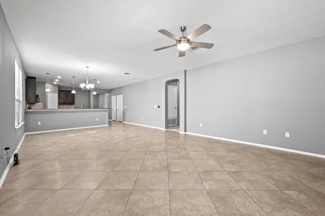 a view of a hallway with chandelier and entryway