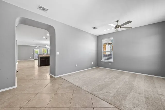 a large kitchen with a large counter top sink appliances and cabinets