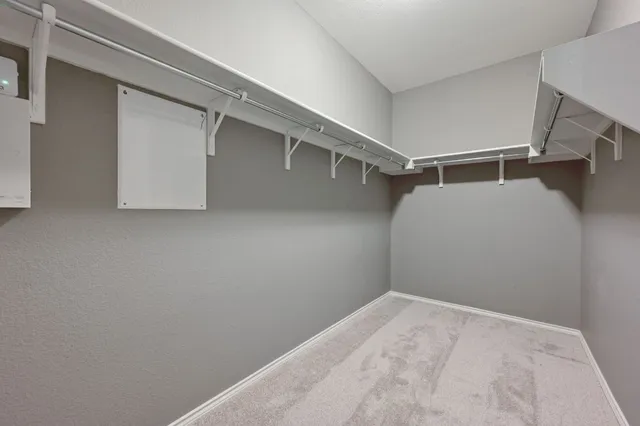 a view of a room with a ceiling fan and a window