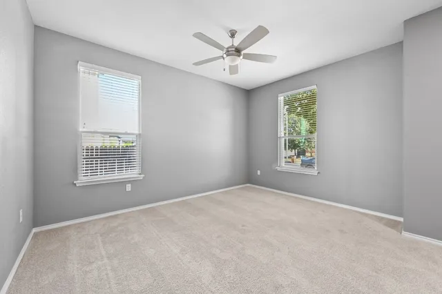 a view of a big room with a ceiling fan