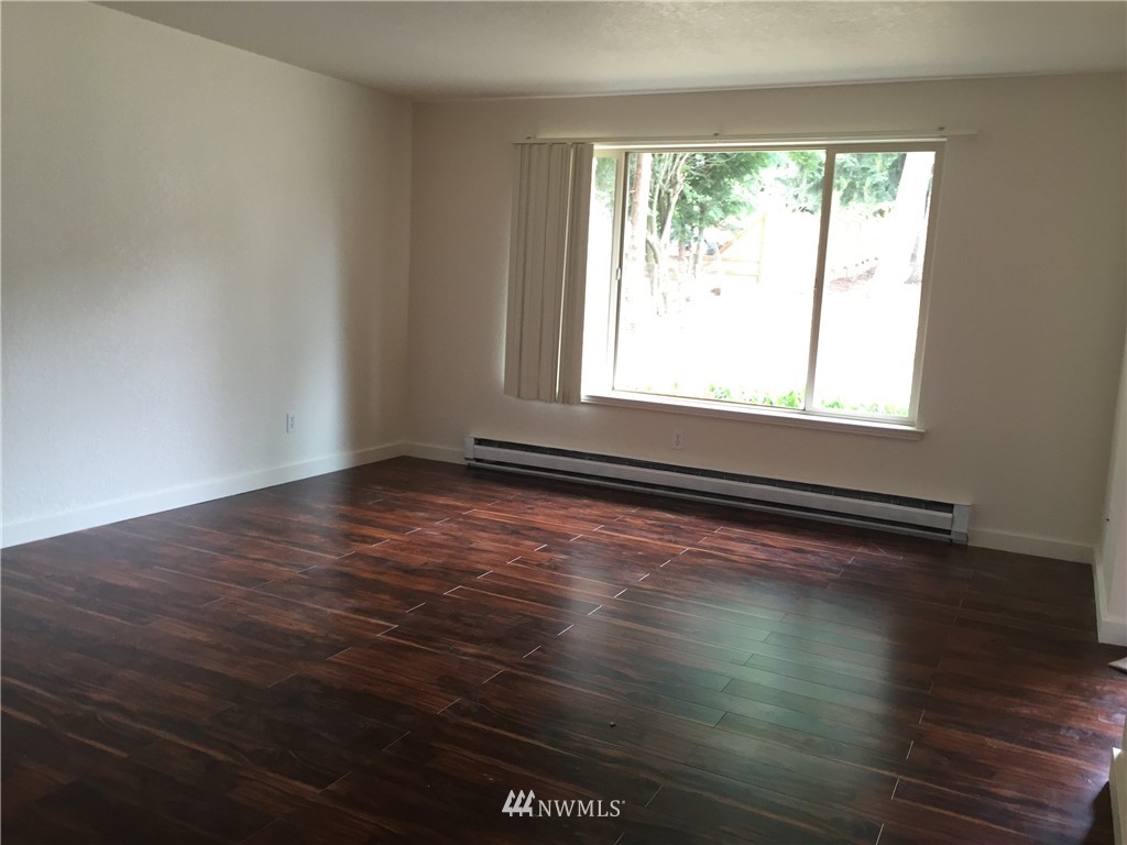 6515 Cady Road Everett, WA 98203 - Photo 7 of 15 an empty room with wooden floor and windows