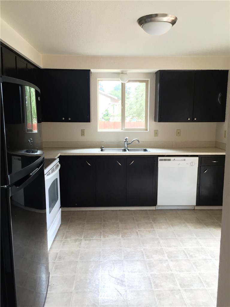6515 Cady Road Everett, WA 98203 - Photo 9 of 15 a kitchen with a sink and large cabinets