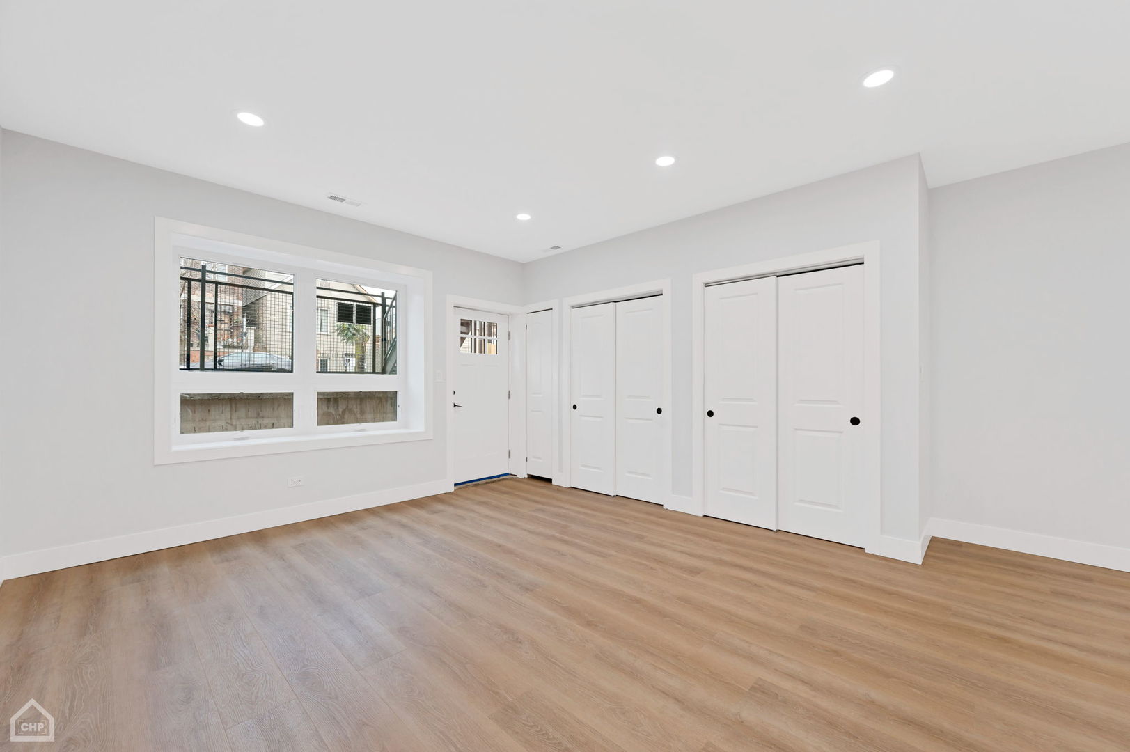 2132 South Fairfield Avenue, Unit 1 Chicago, IL 60608 - Photo 4 of 7 a view of empty room with wooden floor and windows