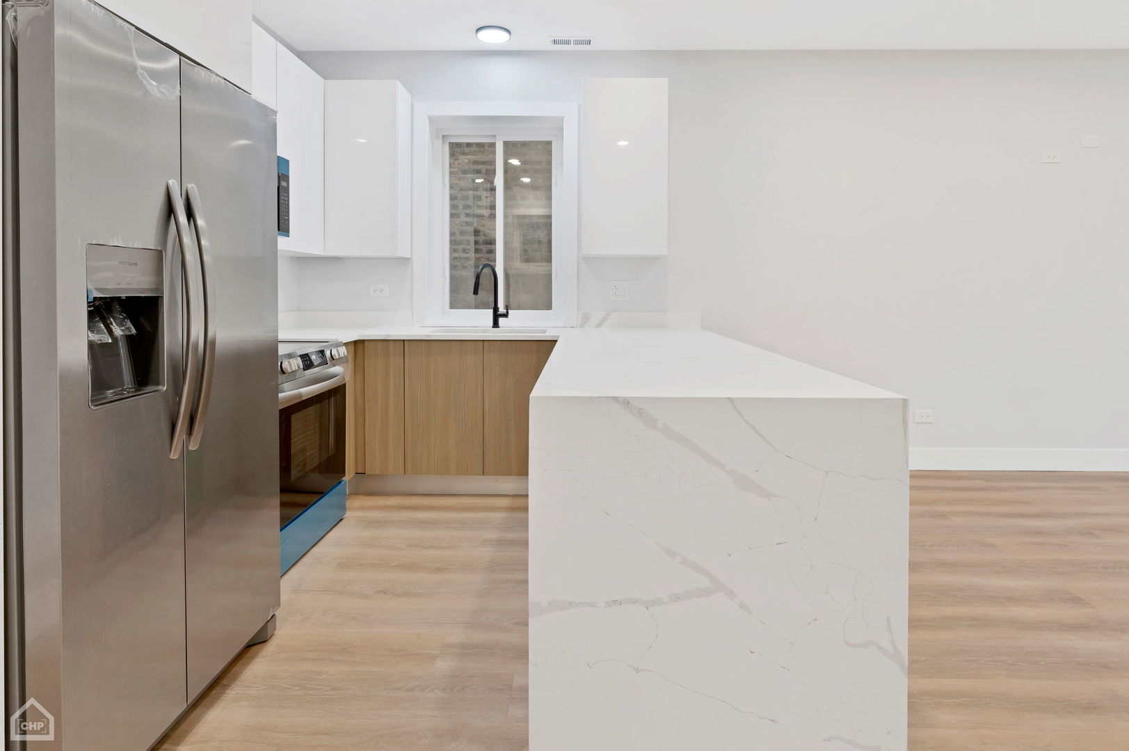 2132 South Fairfield Avenue, Unit 1 Chicago, IL 60608 - Photo 6 of 7 a kitchen with stainless steel appliances a refrigerator and a window