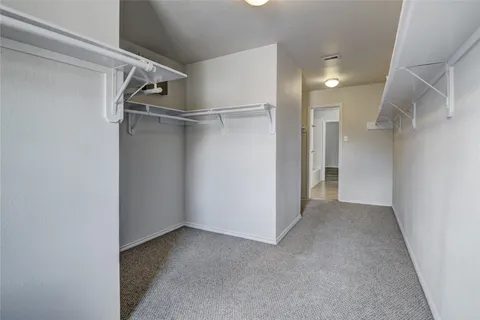 a bathroom with a granite countertop sink a mirror and a bathtub