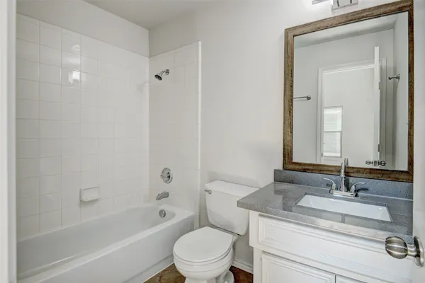 an empty room with wooden floor chandelier and ceiling fan