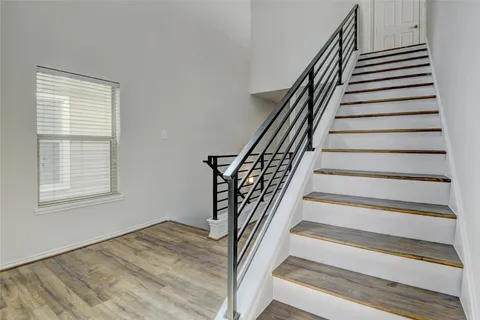 a bathroom with a granite countertop sink a toilet and a bathtub