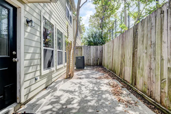 a view of a white house with a small yard and a large space