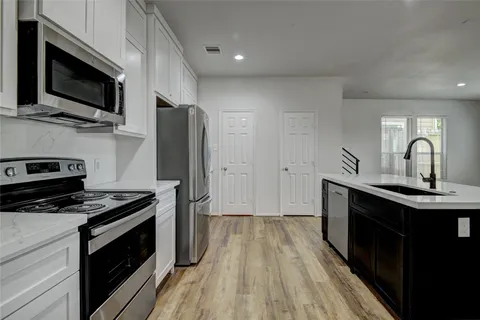 a kitchen with a refrigerator stove and microwave