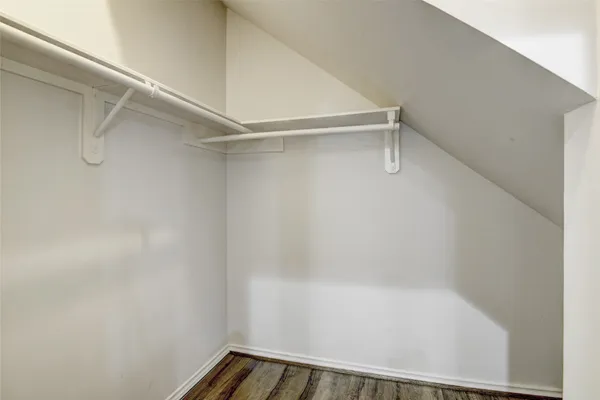 a view of kitchen with kitchen island wooden floor and center island