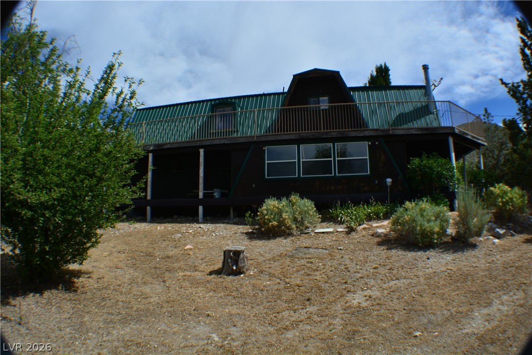 1321 Trout Canyon Road Las Vegas, NV 89124 - Photo 4 of 50 Perched on a hill, this distinctive A-frame offers a spacious balcony overlooking natural landscaping.