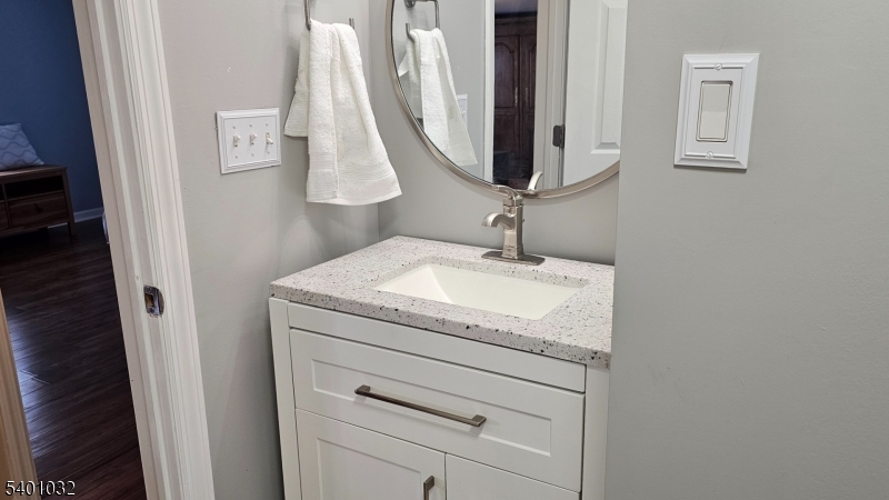 12 Ford Road Landing, NJ 07850 - Photo 11 of 32 a bathroom with a granite countertop sink and a mirror