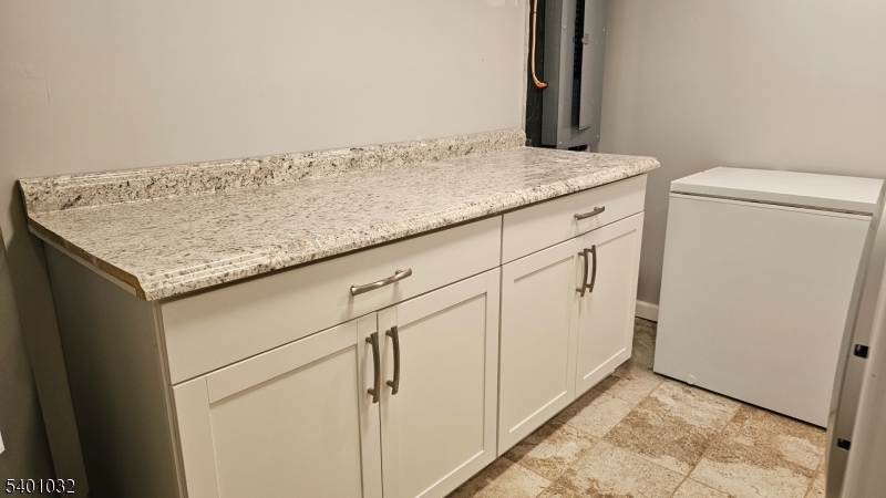 12 Ford Road Landing, NJ 07850 - Photo 12 of 32 a utility room with granite countertop cabinets washer and dryer