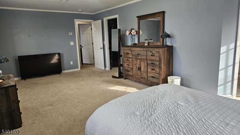 12 Ford Road Landing, NJ 07850 - Photo 17 of 32 a bedroom with a bed and a flat screen tv